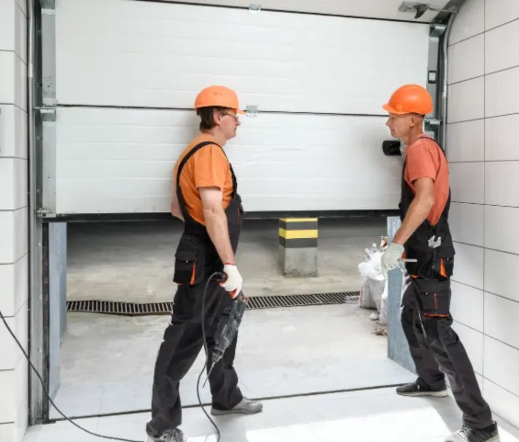 two garage door experts repairing