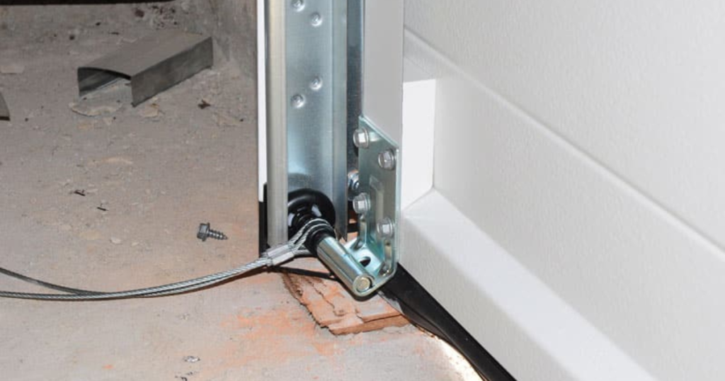 Garage door bottom bracket with cable.