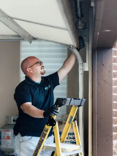 repairman from meadows garage doors fixing sopeners