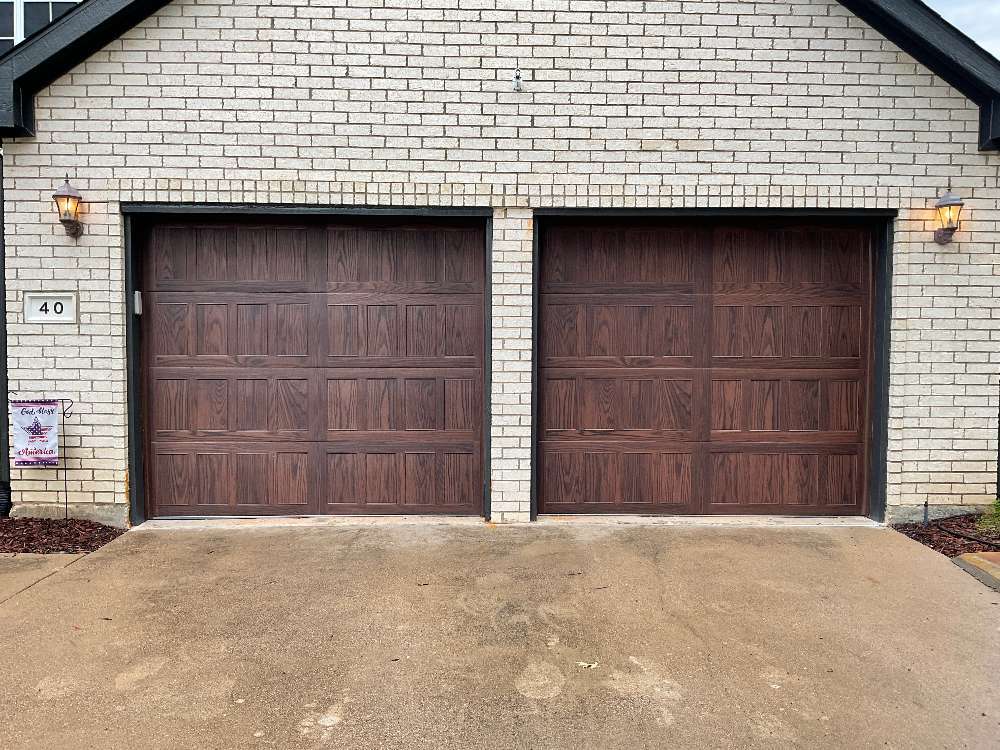 2 wooden paneled single car garage doors
