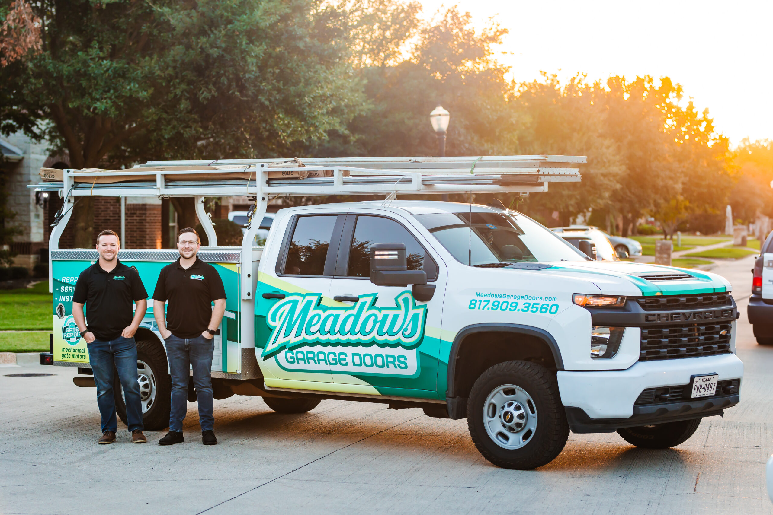 Aaron and Jason Meadows in front of the work truck