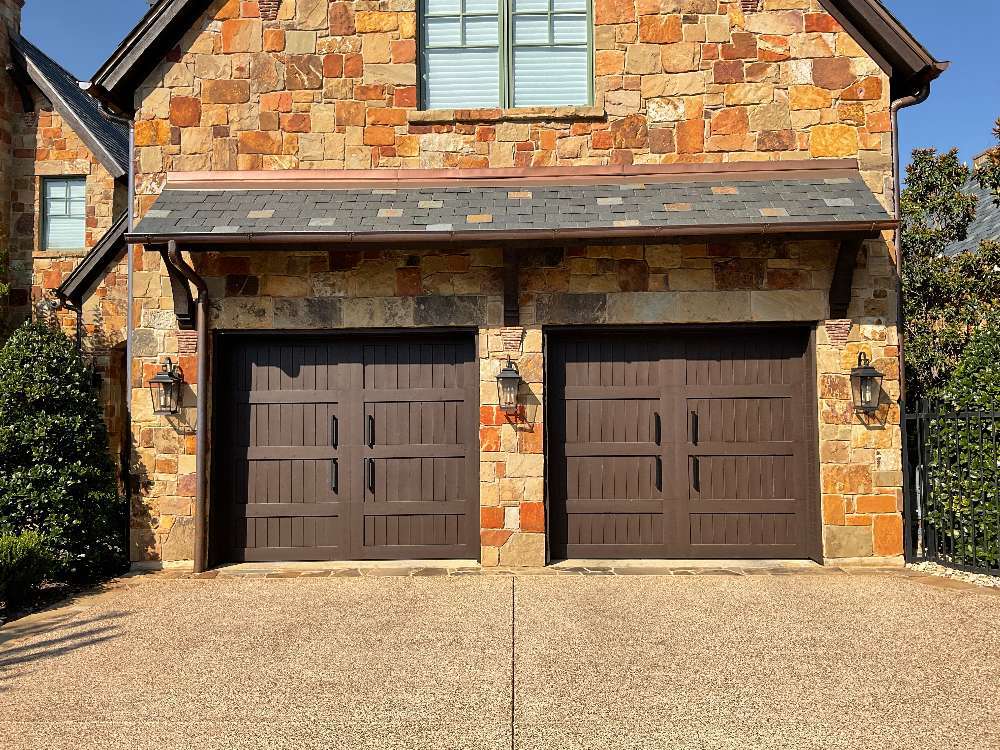 Two brown wooden single car garage doors