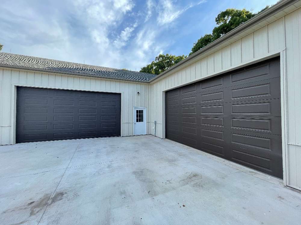 Two traditional two-door brown garage doors