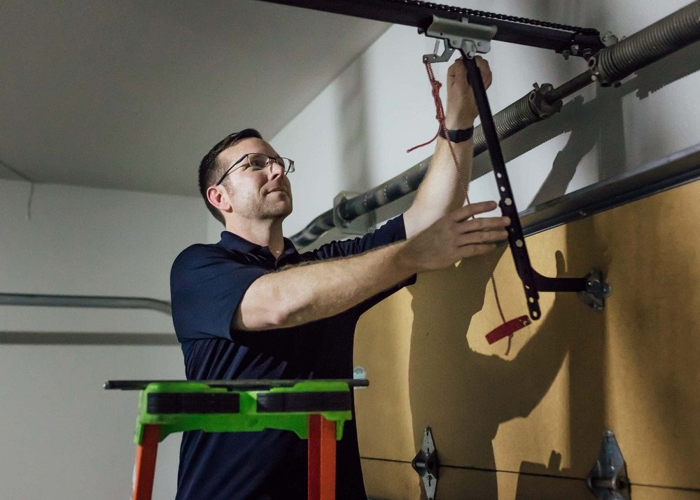 Team member working on garage door spings