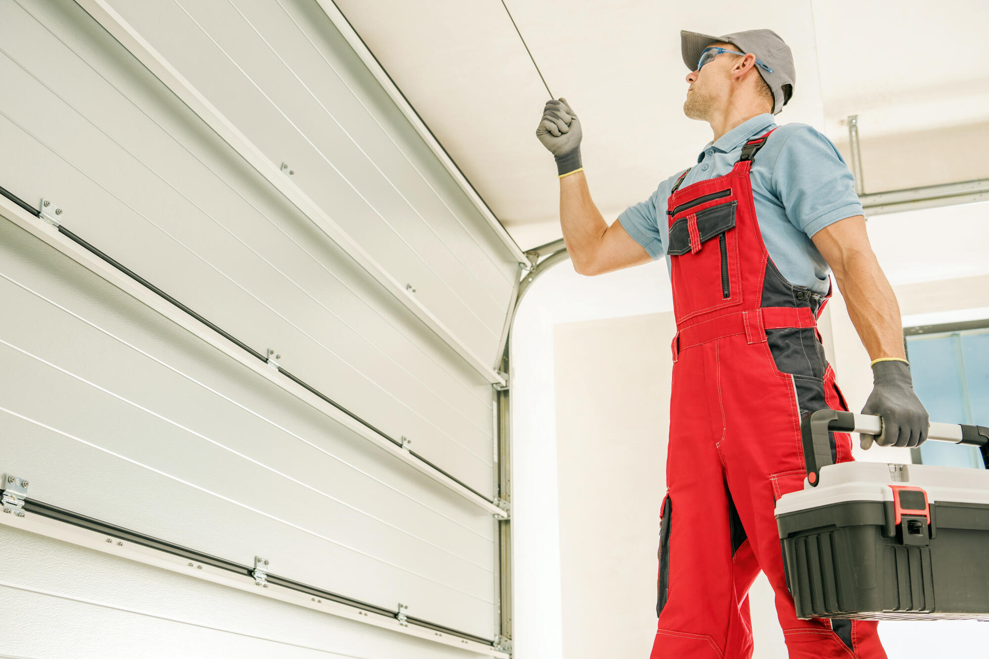 Garage door technician working on cables
