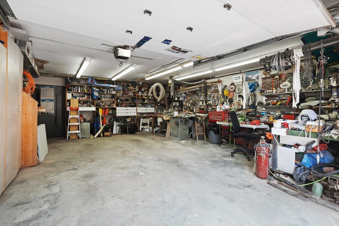 Interior of a garage being used as a workshop.