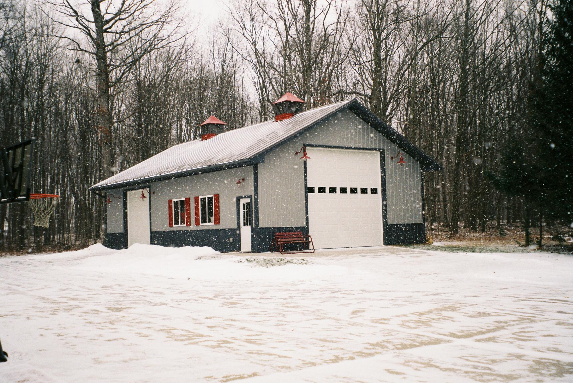 Building with metal garage door in the snow