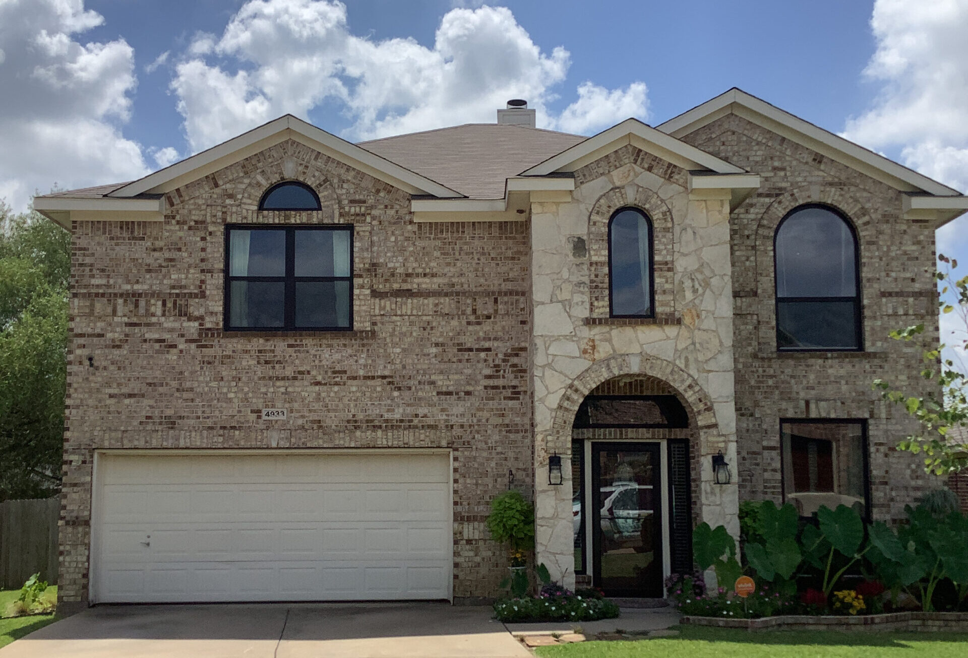 Residential home with white carriage garage door.