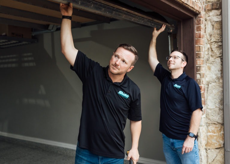 Aaron and Jason Meadows inspecting a garage.