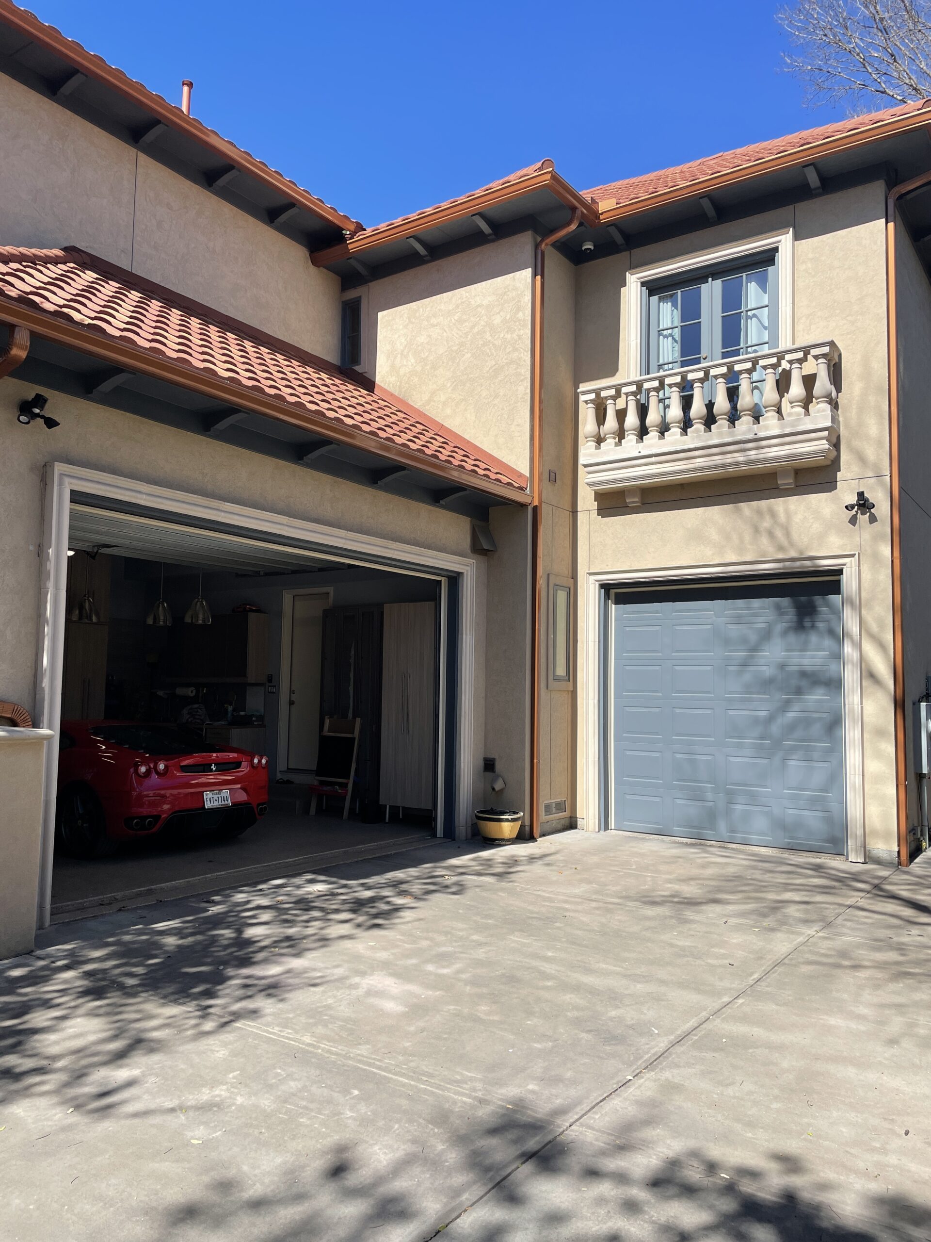 Blue garage door spanish style house