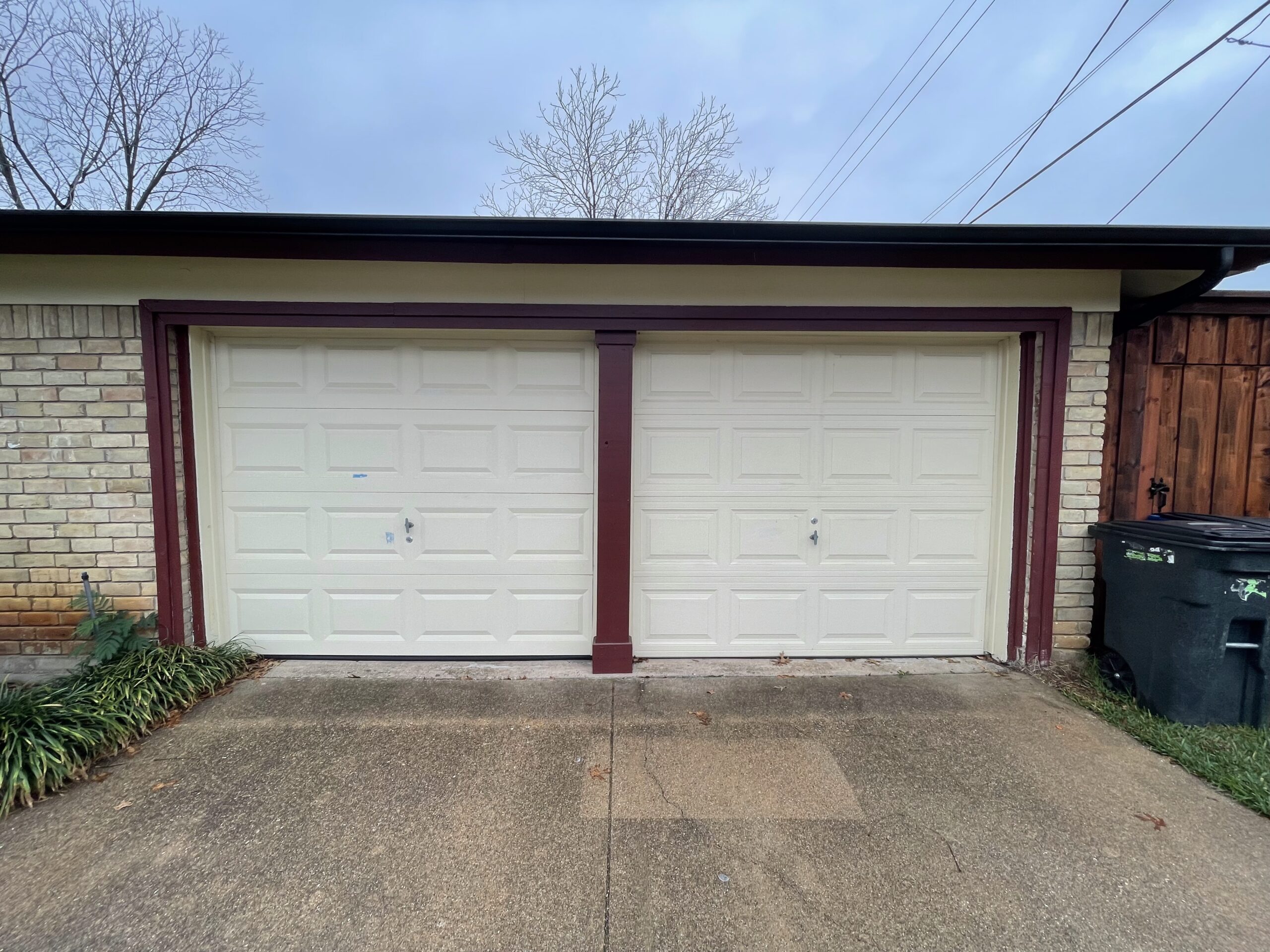 Two door residential white aluminum garage door.