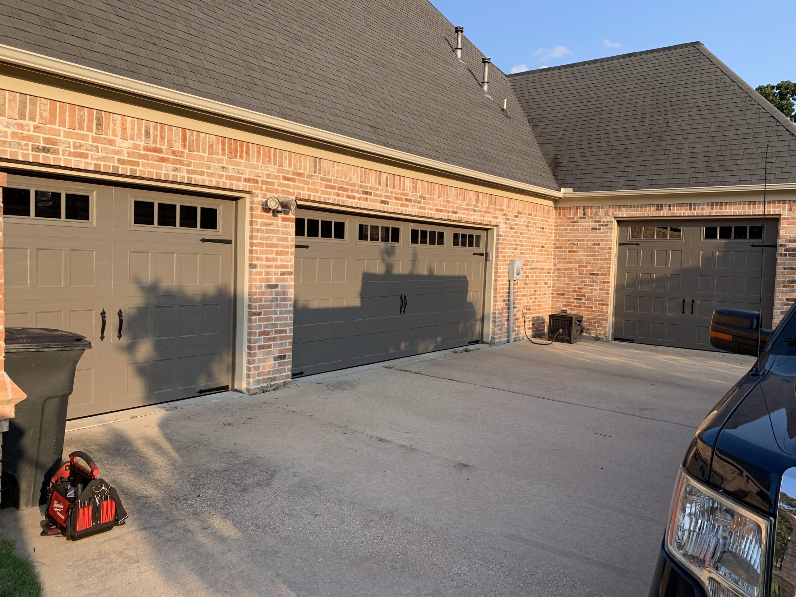 Three door, four car residential windowed aluminum garage doors.