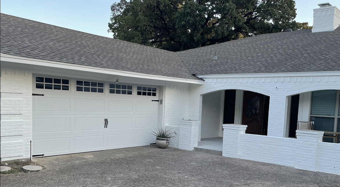 Two car windowed garage door, white aluminum.