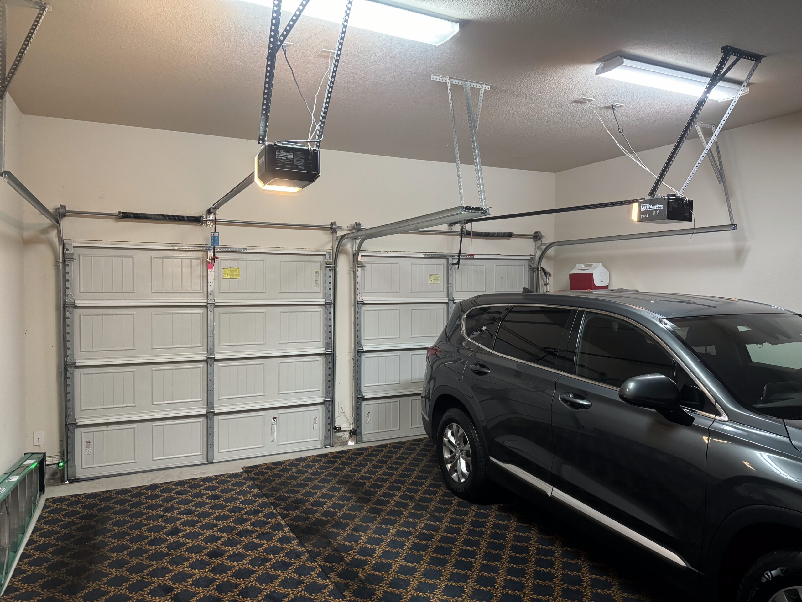 Two door, two car garage door interior. Liftmaster garage door openers.
